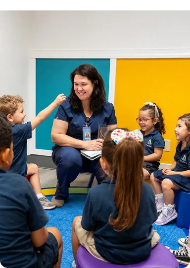 Teacher reading to a circle of children in a Harbor classroom